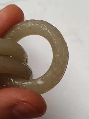 Lot 917 - FOUR CHINESE CARVED WHITE JADE CONJOINED RINGS.