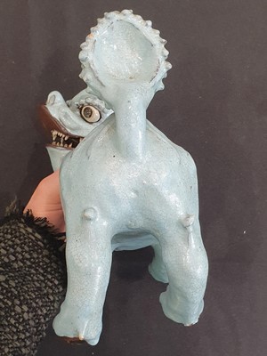 Lot 706 - A PAIR OF CHINESE PALE BLUE GLAZED MODELS OF MYTHICAL BEASTS.
