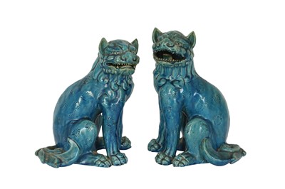 Lot 747 - A NEAR-PAIR OF JAPANESE TURQUOISE-GLAZED LION DOGS.