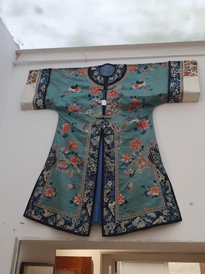 Lot 293 - A CHINESE PALE BLUE GROUND INFORMAL LADY'S ROBE.