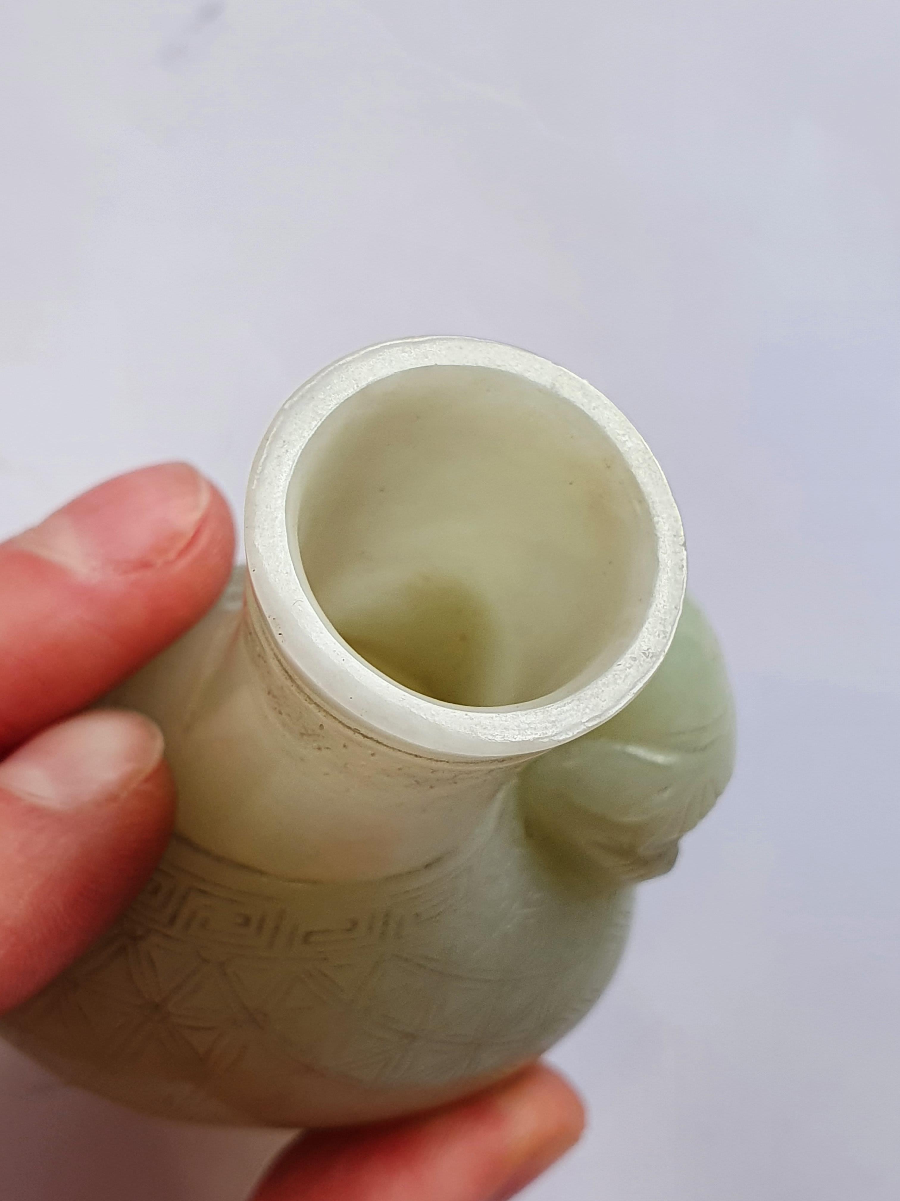 Lot 367 A CHINESE PALE CELADON JADE MINIATURE VASE.