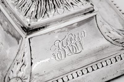 Lot 654 - A pair of George III sterling silver dwarf or desk candlesticks, Sheffield 1776 by J Hoyland & Co, overstruck for London by Robert Jones and John Scofield (reg. 10th February 1776)