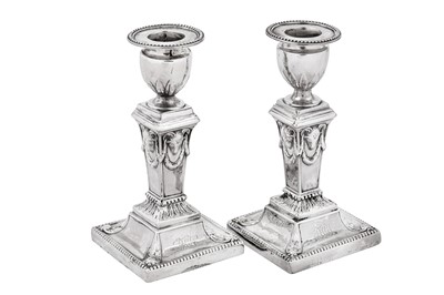 Lot 654 - A pair of George III sterling silver dwarf or desk candlesticks, Sheffield 1776 by J Hoyland & Co, overstruck for London by Robert Jones and John Scofield (reg. 10th February 1776)