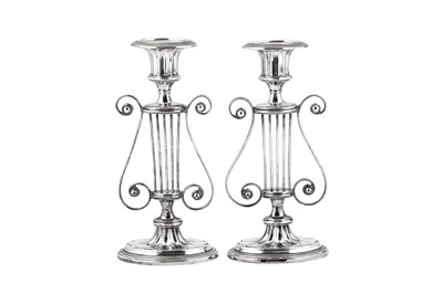 Lot 579 - A pair of Edwardian sterling silver candlesticks, Birmingham 1903 by Israel Sigmund Greenberg and Co