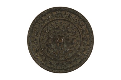 Lot 993 - A CHINESE BRONZE 'LION AND GRAPEVINE' MIRROR.