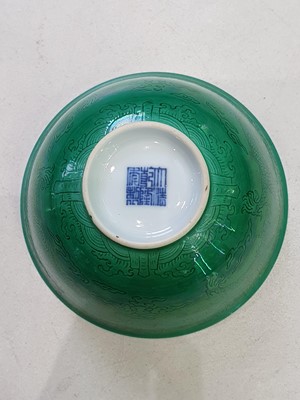 Lot 123 - A PAIR OF CHINESE INCISED GREEN-GLAZED 'DRAGON' BOWLS.