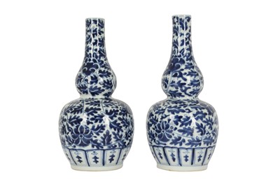 Lot 615 - A PAIR OF CHINESE BLUE AND WHITE DOUBLE GOURD VASES.