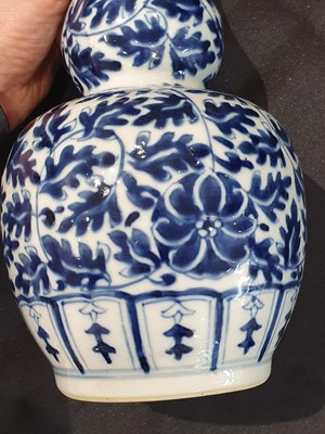 Lot 615 - A PAIR OF CHINESE BLUE AND WHITE DOUBLE GOURD VASES.
