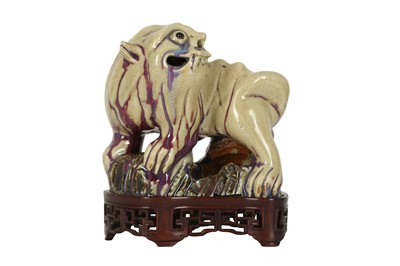 Lot 750 - A CHINESE FLAMBÉ-GLAZED MODEL OF A LION DOG.