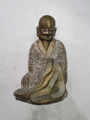 Lot 608 - A CHINESE BRONZE FIGURE OF A LUOHAN.