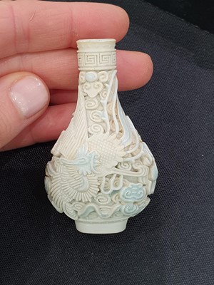 Lot 150 - A CHINESE BISCUIT 'DRAGON AND PHOENIX' SNUFF BOTTLE.