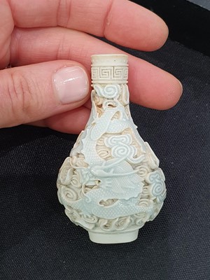 Lot 150 - A CHINESE BISCUIT 'DRAGON AND PHOENIX' SNUFF BOTTLE.
