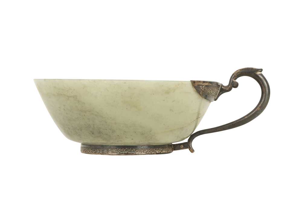Lot 18 - A PALE CELADON JADE CUP WITH A WHITE METAL HANDLE.