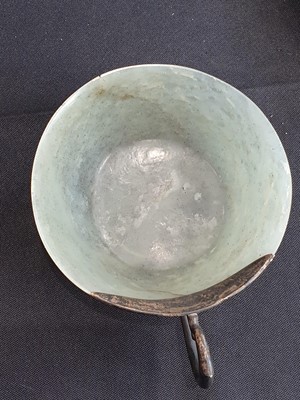 Lot 18 - A PALE CELADON JADE CUP WITH A WHITE METAL HANDLE.