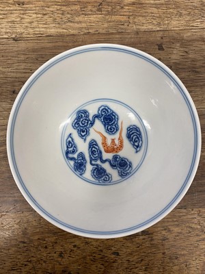 Lot 214 - A CHINESE BLUE AND WHITE AND IRON-RED 'BATS AND CLOUDS' BOWL.