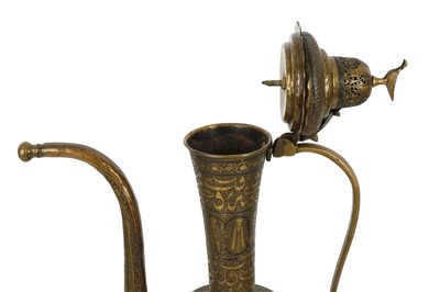 Lot 623 - A ZAND-STYLE SILVER-INLAID BRASS EWER MADE FOR THE IRANIAN MARKET