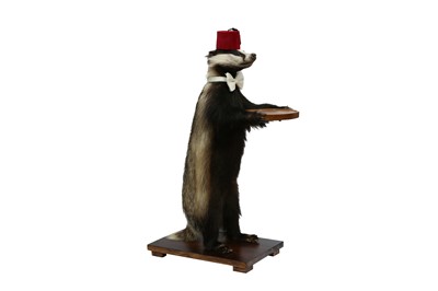 Lot 14 - TAXIDERMY: A BADGER (MELES MELES) WAITER WEARING A FEZ AND A BOW TIE