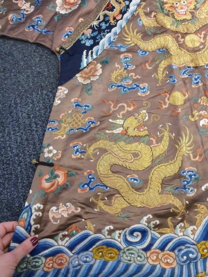 Lot 289 - A CHINESE CHESTNUT-GROUND EMBROIDERED 'DRAGON' ROBE.