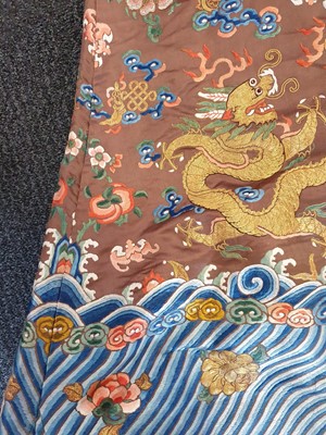 Lot 289 - A CHINESE CHESTNUT-GROUND EMBROIDERED 'DRAGON' ROBE.