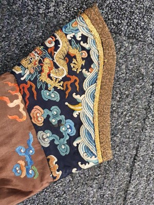 Lot 289 - A CHINESE CHESTNUT-GROUND EMBROIDERED 'DRAGON' ROBE.