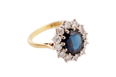 Lot 23 - A sapphire and diamond cluster ring