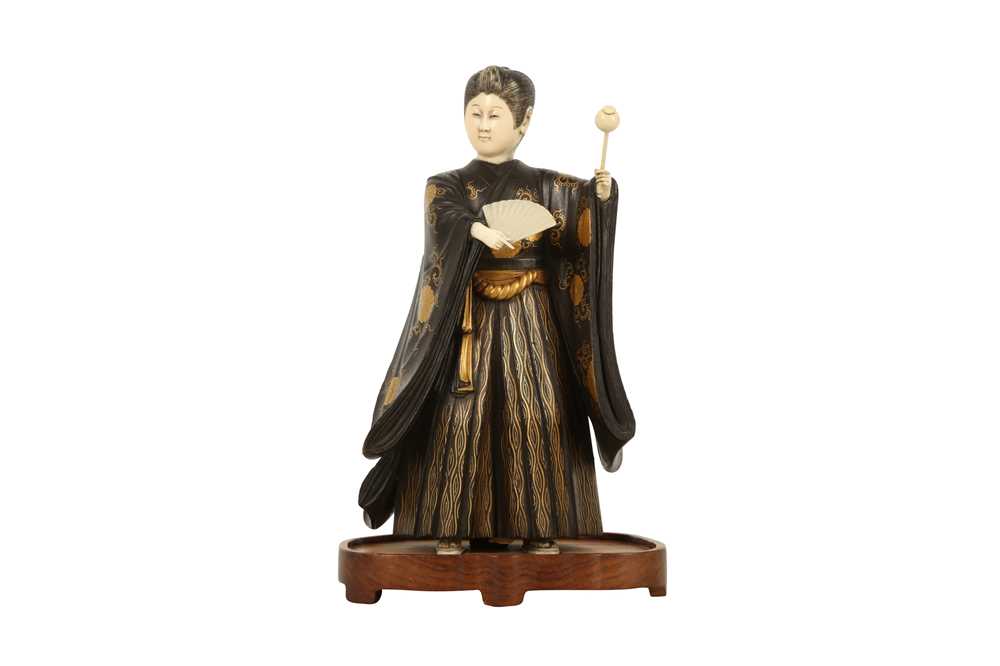 Lot 461 - A WOOD AND IVORY OKIMONO OF AN ENTERTAINER.
