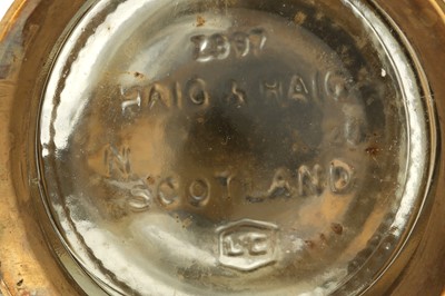 Lot 632 - AN ENAMELLED BRASS MOUNTED HAIG'S DIMPLE WHISKEY BOTTLE