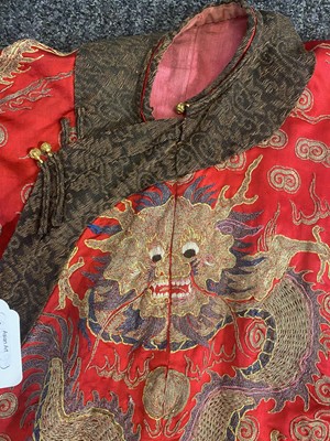 Lot 298 - A CHINESE EMBROIDERED RED-GROUND SILK 'DRAGON AND PHOENIX' JACKET.