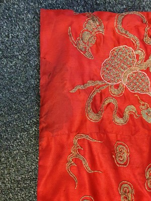 Lot 298 - A CHINESE EMBROIDERED RED-GROUND SILK 'DRAGON AND PHOENIX' JACKET.