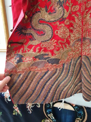 Lot 378 - A CHINESE RED-GROUND EMBROIDERED SILK 'DRAGON AND PHOENIX' JACKET.