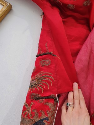 Lot 378 - A CHINESE RED-GROUND EMBROIDERED SILK 'DRAGON AND PHOENIX' JACKET.