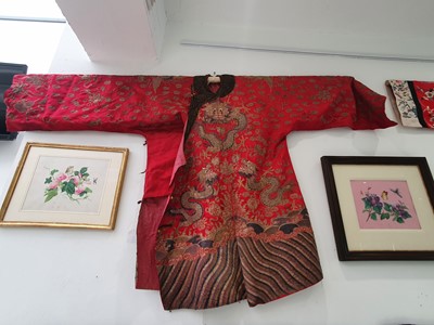 Lot 378 - A CHINESE RED-GROUND EMBROIDERED SILK 'DRAGON AND PHOENIX' JACKET.