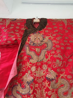 Lot 378 - A CHINESE RED-GROUND EMBROIDERED SILK 'DRAGON AND PHOENIX' JACKET.