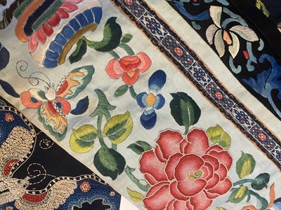 Lot 299 - A CHINESE EMBROIDERED BLUE-GROUND SILK LADY'S ROBE.