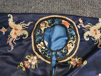 Lot 299 - A CHINESE EMBROIDERED BLUE-GROUND SILK LADY'S ROBE.