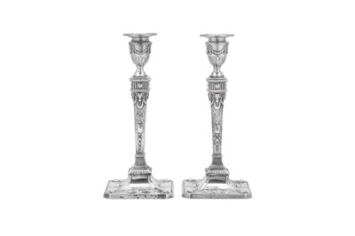 Lot 384 - A pair of Edwardian sterling silver candlesticks, Sheffield 1907 by Martin, Hall and Co