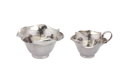 Lot 330 - A Victorian ‘Arts and Crafts’ sterling silver three-piece bachelor tea set, London 1883/84 by Hukin and Heath