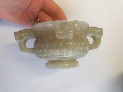 Lot 19 - A CHINESE PALE CELADON JADE ARCHAISTIC CUP.
