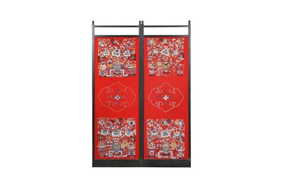 Lot 385 - A PAIR OF CHINESE RED-GROUND EMBROIDERED CHAIR COVERS MOUNTED AS A SCREEN.