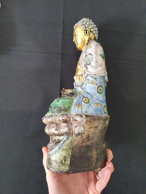 Lot 267 - A CHINESE ENAMELLED AND GILT-DECORATED FIGURE OF A BUDDHA.