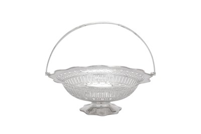 Lot 365 - A George V sterling silver cake basket, Sheffield 1922 by William Hutton and Son