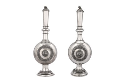 Lot 577 - A PAIR OF LARGE EMBOSSED AND ENGRAVED SILVER BOTTLES (SURAHI)