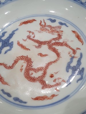 Lot 133 - A CHINESE YELLOW-GROUND AND A BLUE AND WHITE AND IRON-RED 'DRAGON' DISH.