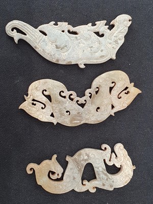 Lot 168 - A SET OF CHINESE PALE CELADON JADE CHIMES AND PENDANTS.