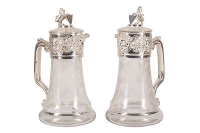 Lot 210 - A PAIR OF SILVER PLATED AND ETCHED GLASS CLARET JUGS