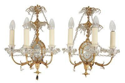 Lot 197 - A SET OF FOUR GILT AND MIRRORED THREE LIGHT SCONCES