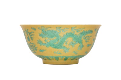 Lot 663 - A CHINESE GREEN-ENAMELLED YELLOW-GROUND 'DRAGON AND PHOENIX' BOWL.