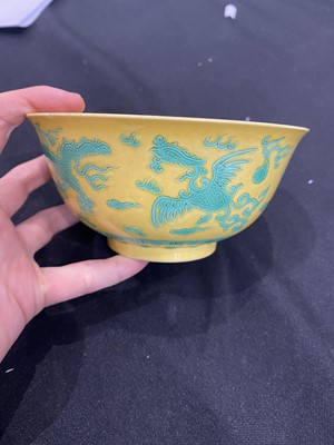 Lot 663 - A CHINESE GREEN-ENAMELLED YELLOW-GROUND 'DRAGON AND PHOENIX' BOWL.
