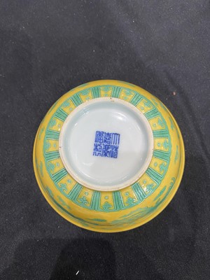 Lot 663 - A CHINESE GREEN-ENAMELLED YELLOW-GROUND 'DRAGON AND PHOENIX' BOWL.