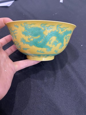 Lot 663 - A CHINESE GREEN-ENAMELLED YELLOW-GROUND 'DRAGON AND PHOENIX' BOWL.